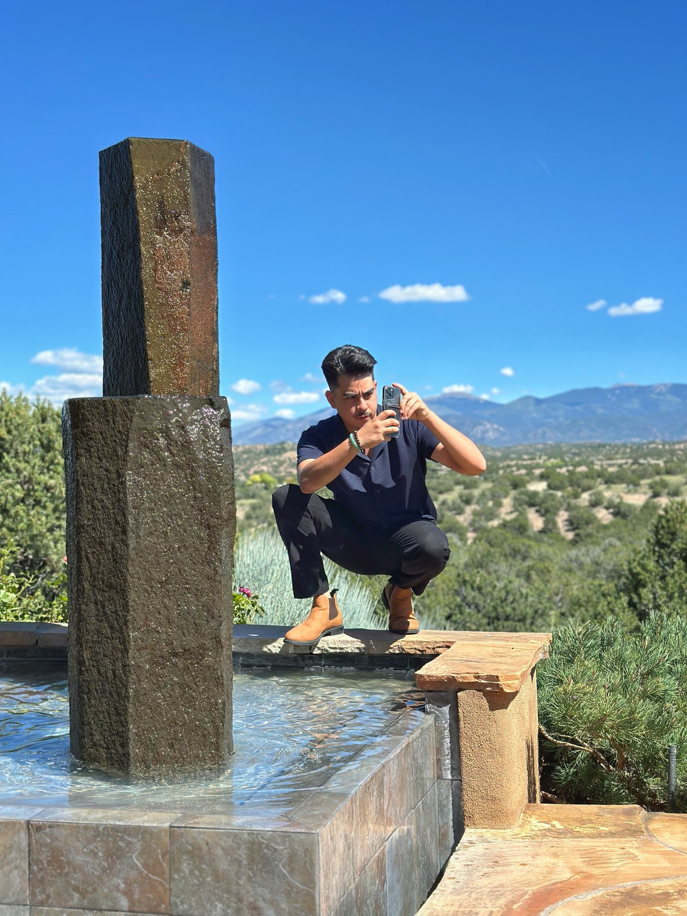 Aram Herrera framing a shot at a Santa Fe property